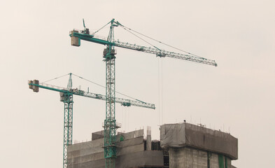 Tower crane at a construction site at sunset