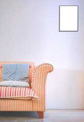 Part of comfortable fabric beige sofa and blue cushion with blank transparent in picture frame on white wall in vintage living room, png file