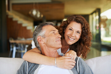 Portrait, mature and happy couple hug in home living room for love, connection or trust for...