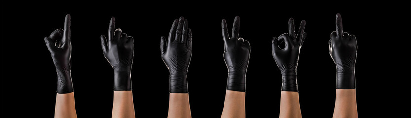 Hands in black gloves showing different gestures, pointing and showing signs