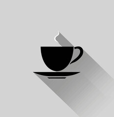 a cup of coffee on a saucer with a long shadow