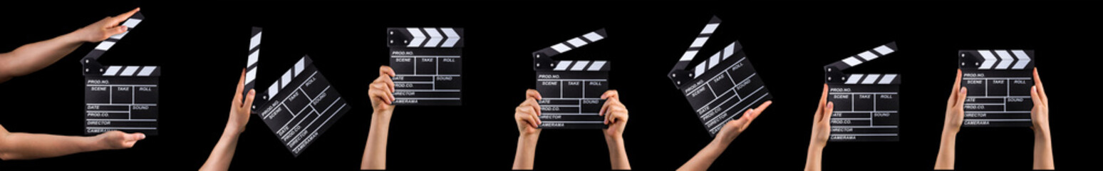 Human hand holding film clapper board isolated on black background.