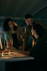 Teamwork, computer and business people in discussion at night for planning, online networking and internet. Office, creative startup and men and women on laptop for research, website and meeting