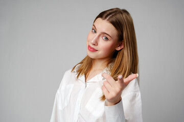 Young Woman in White Shirt Gesturing Come Here With Both Hands