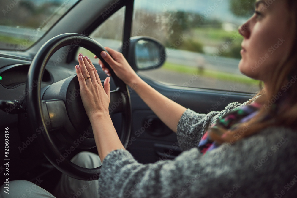 Wall mural woman, car and driving with honk on road for alert, emergency or traffic in travel, trip or transpor