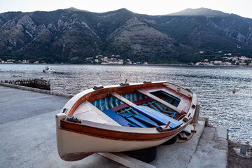 Wooden boat moored at coast of Kotor Bay in Montenegro