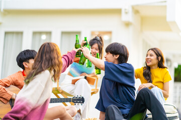 Group of young Asian woman enjoy and fun celebration meeting party at home backyard with playing...