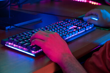 A gamer engaged in gameplay, surrounded by a vibrant and colorful setup