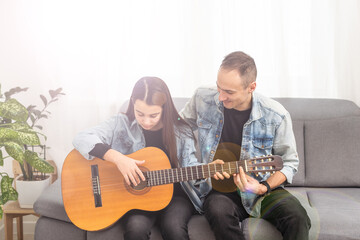 Guitar teacher teaching the little girl