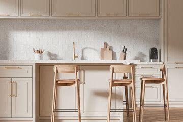 Fototapeta premium Beige kitchen interior with bar countertop and seats, shelves and kitchenware