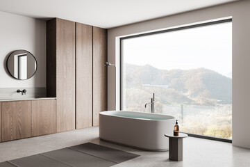 Wooden home bathroom interior with tub and sink, panoramic window