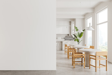 Modern kitchen and dining area with wooden chairs and white tables, minimalistic style, light...