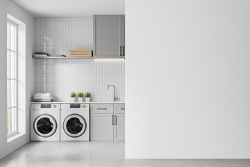 Grey home laundry interior with washing cabinet and sink, window. Mockup wall