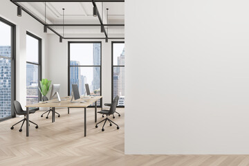Business coworking interior with tables and pc desktop, window. Mock up wall