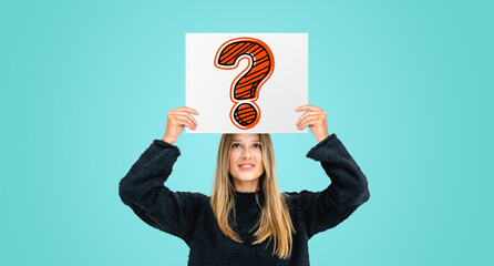 Young woman holding poster with question mark on colored background