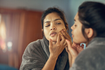 Skincare, mirror and woman pop pimple in bedroom at home for clean or smooth facial treatment....