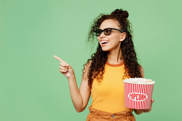 Young woman wear yellow tank shirt top 3d glasses watch movie film hold bucket of popcorn cup of...