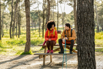 Couple Resting on Bench During Forest Hike