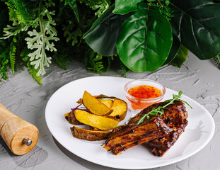 Barbecue ribs with garnish on elegant plate