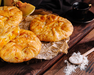 Freshly baked pumpkin pastries on wooden table