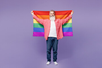 Full body smiling happy elderly bearded gay man 50s years old wears casual clothes wrapped in...