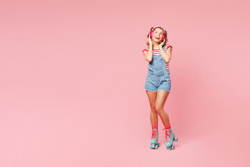 Full body young woman wear red t-shirt denim overalls casual clothes blue rollers rollerblading...