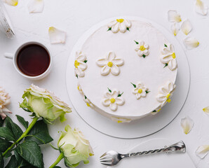 Elegant white floral cake with tea setting