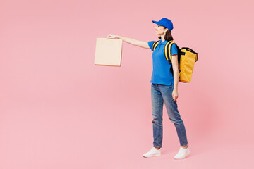 Full body delivery employee woman wear blue cap t-shirt uniform workwear yellow thermal food bag...