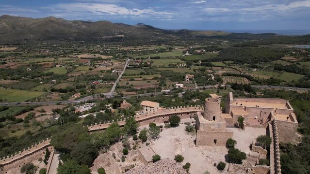 Aerial View of Castle Surrounded by Mountains