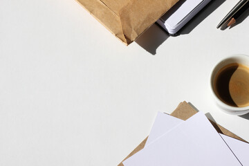 Home Office Workspace with Papers, Notebook, Stationery, Cup of Coffee on White Background. 