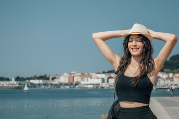 smiling woman with arms raised free and relaxed outside