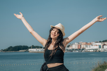 cheerful woman with arms raised celebrating the beautiful day