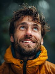 Fototapeta premium portrait of a happy man looking up in the rain