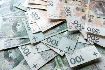 Financial background with many polish zloty banknotes 100 200 zl pln