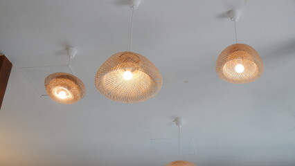basketry design lights decorated on the white ceiling in a coffee shop, minimal decoration