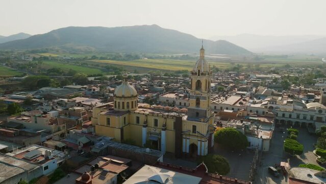 Panoramic aerial surveying flight of the Santuario Diosesano  church in Tamazula de Gordiano city center, right to left orbit