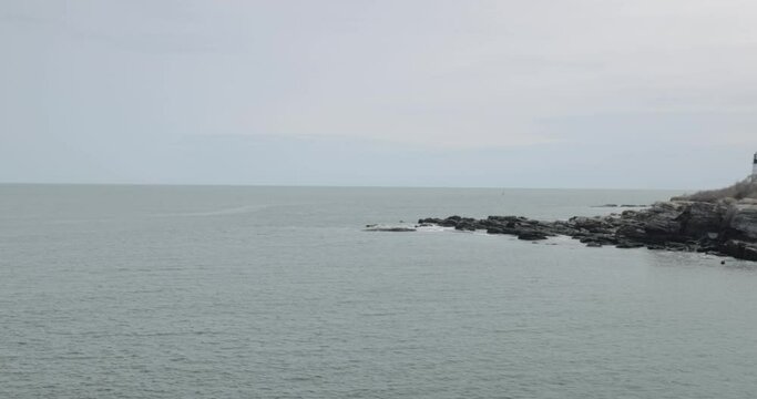 View of the Atlantic ocean panning across the rocky shore line.