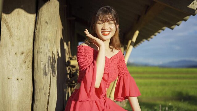 A farmer woman with fresh paddy rice terraces, green agricultural fields in countryside or rural area of Mu Cang Chai, mountain hills valley in Asia, Vietnam. Nature landscape. People lifestyle.