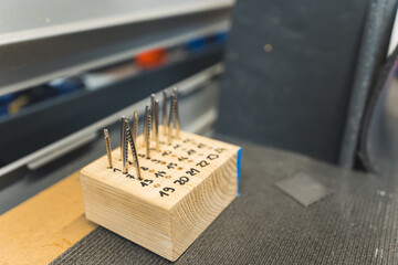 shot of guitar frets placed in the wooden cube before adding on a guitar, guitar factory. High quality photo