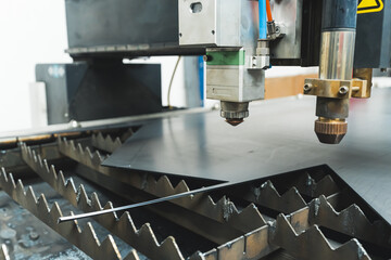 The fiber laser cutting machine cutting machine cut the metal plate. The hi-technology sheet metal manufacturing process by laser cutting machine. High quality photo