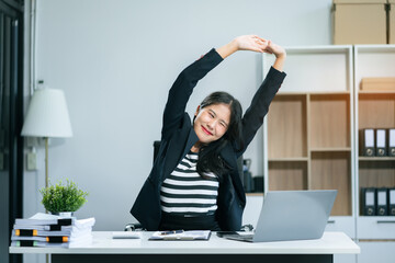 Businesswoman is doing a stretchy posture due to sitting in the office for too long, office...