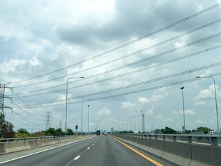 The supply of electricity by wire to the city limits wiht blue sky and cloud, High voltage poles in the countryside Thailand.