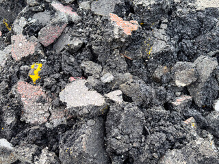 Pile of old cracked asphalt rubble close up, abstract industrial background.