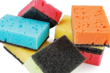 A set of colorful sponges scattered on a white background.