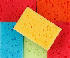 Beautiful background of multi-colored sponges. Bright colored sponges for washing dishes.
