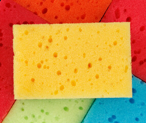 Beautiful background of multi-colored sponges. Bright colored household sponges.