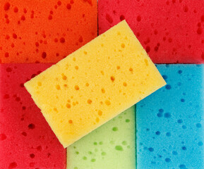 Beautiful background of multi-colored sponges. Bright colored household sponges.