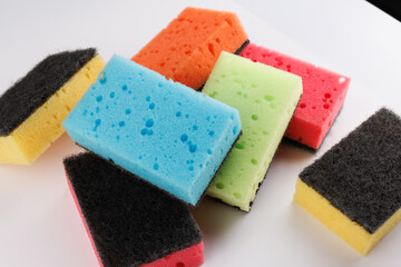 A multi-colored cleaning sponge scattered across the surface. Multi-colored household sponge.