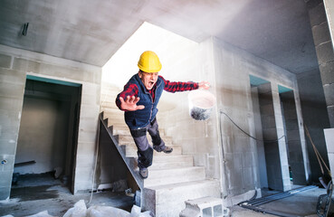 Man falling down the stairs. Accident of a man worker at the construction site. Work injury,...