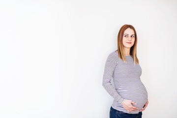 Obraz premium Beautiful pregnant woman touching her belly.